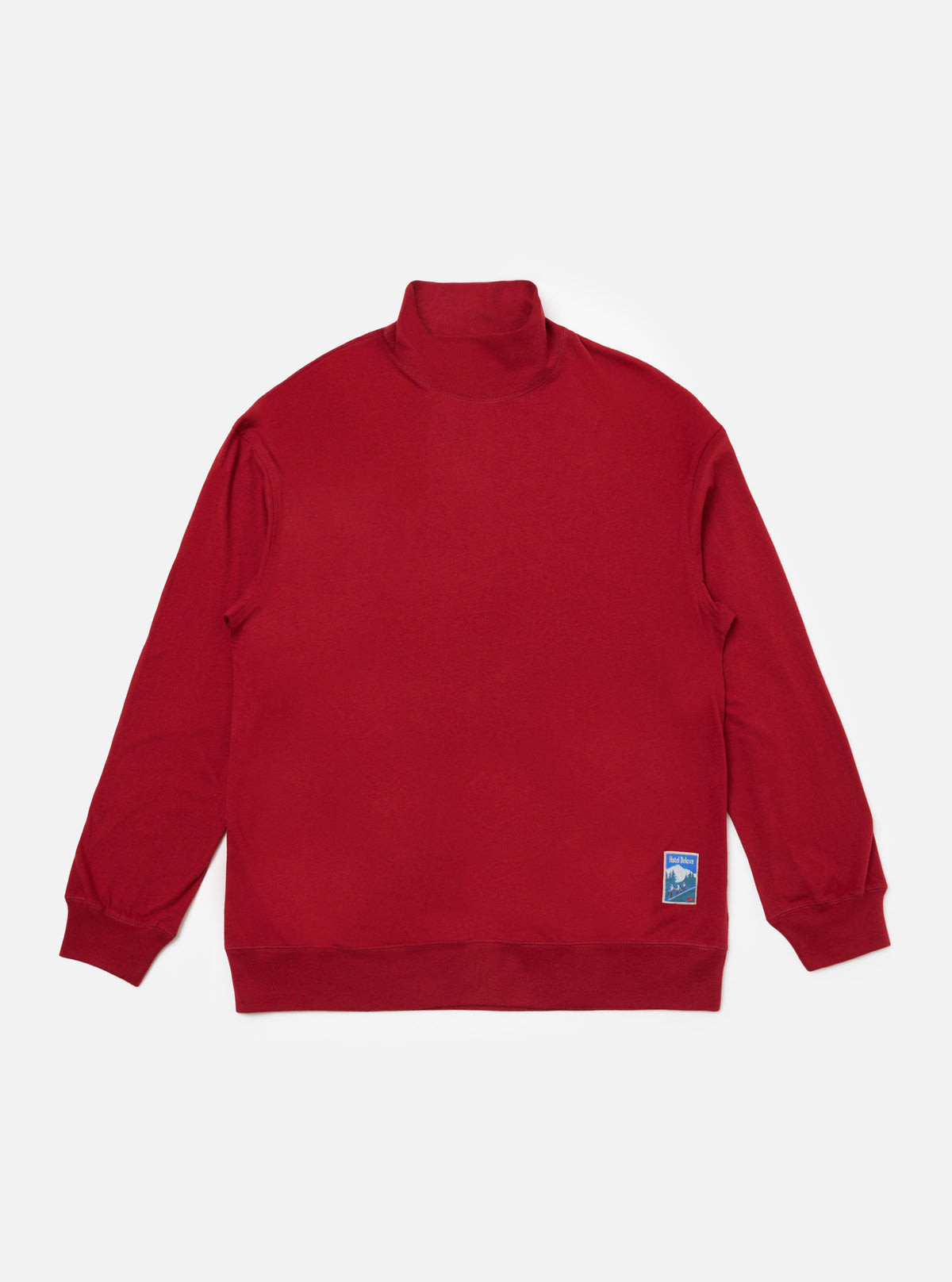 The Red Single Jersey Funnel Neck Tee is laid flat on a white background. The tee is red and made of a soft jersey material. It has a relaxed fit and a funnel neck.