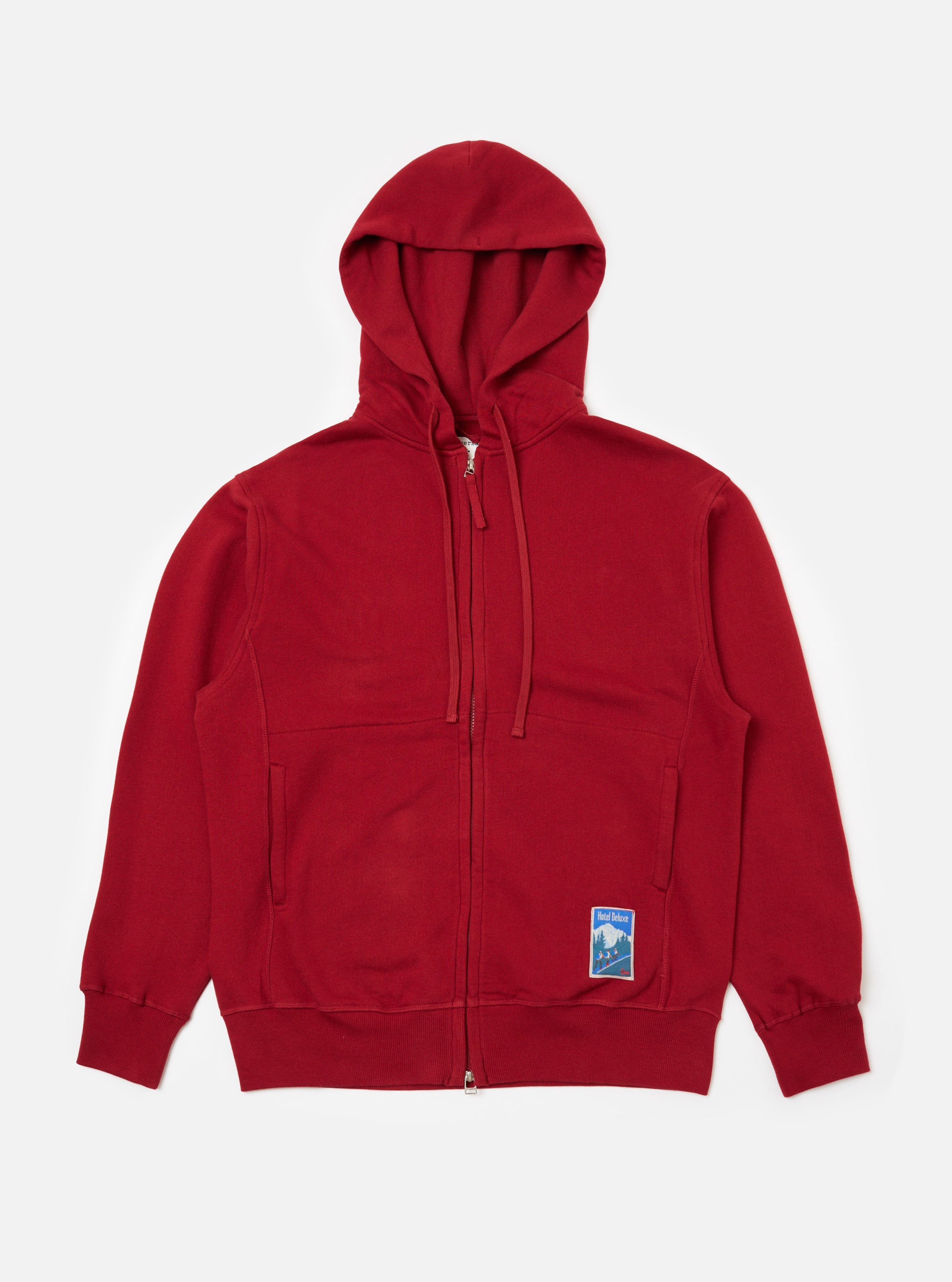 Studio shot of the Red Brush Back Sweat New York Hoody, a zip-up hoodie in red cotton. The hoody is laid flat on a white background.