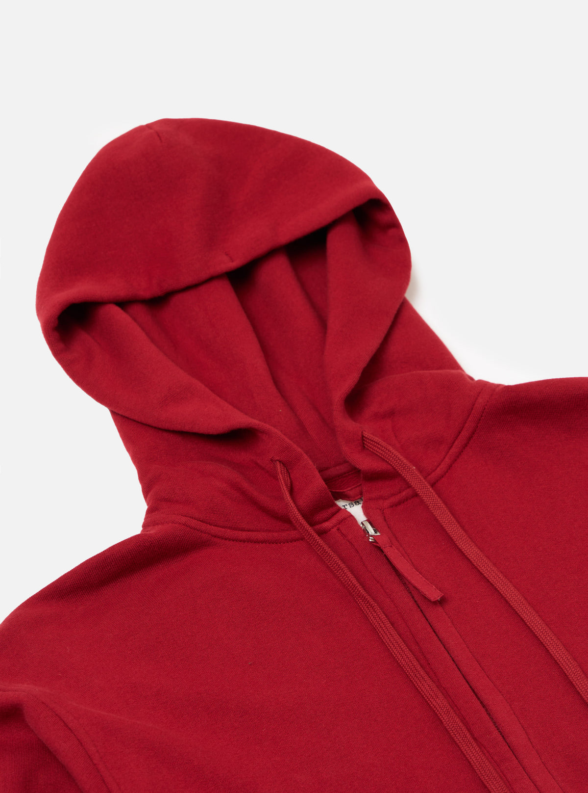 Close-up of the Red Brush Back Sweat New York Hoody on a white background. The red cotton hoody has a full zip and drawstring hood.