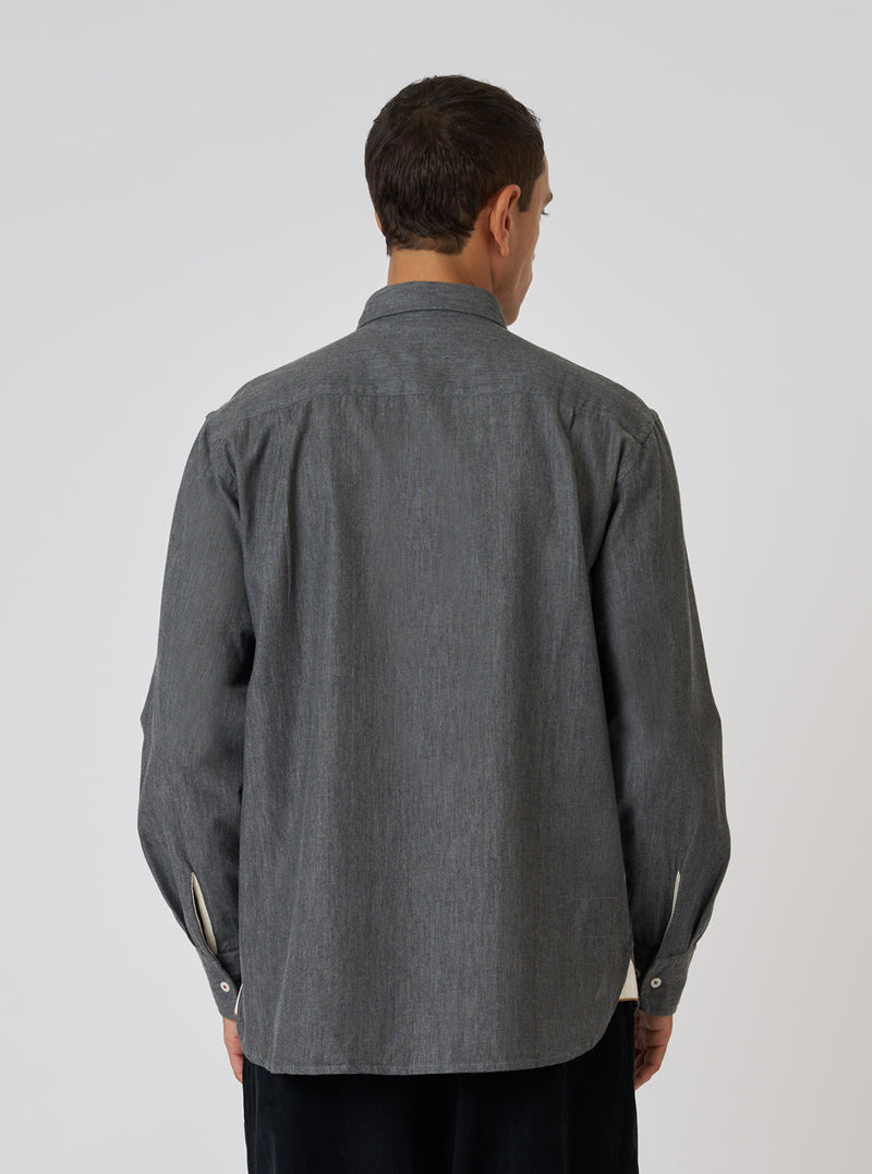 Back view of a model wearing a Charcoal Brushed Organic Cotton Square Pocket Shirt. The shirt is charcoal gray and made of organic cotton. The background is a plain white.