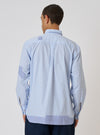 Back view of a model wearing the Blue Office Stripe Patched Lazy Day Shirt. The shirt is blue and white striped with patched detailing. Shot against a white background.