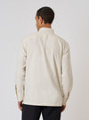 Back view of a model wearing the Ecru Sid Flannel CPO Shirt. The shirt is a light beige color and has a relaxed fit. The background is a plain white studio backdrop.
