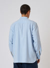 Back view of a man wearing a Light Blue Brushed Marl Twill Square Pocket Shirt. The shirt is on a white background, showing the texture and fit.