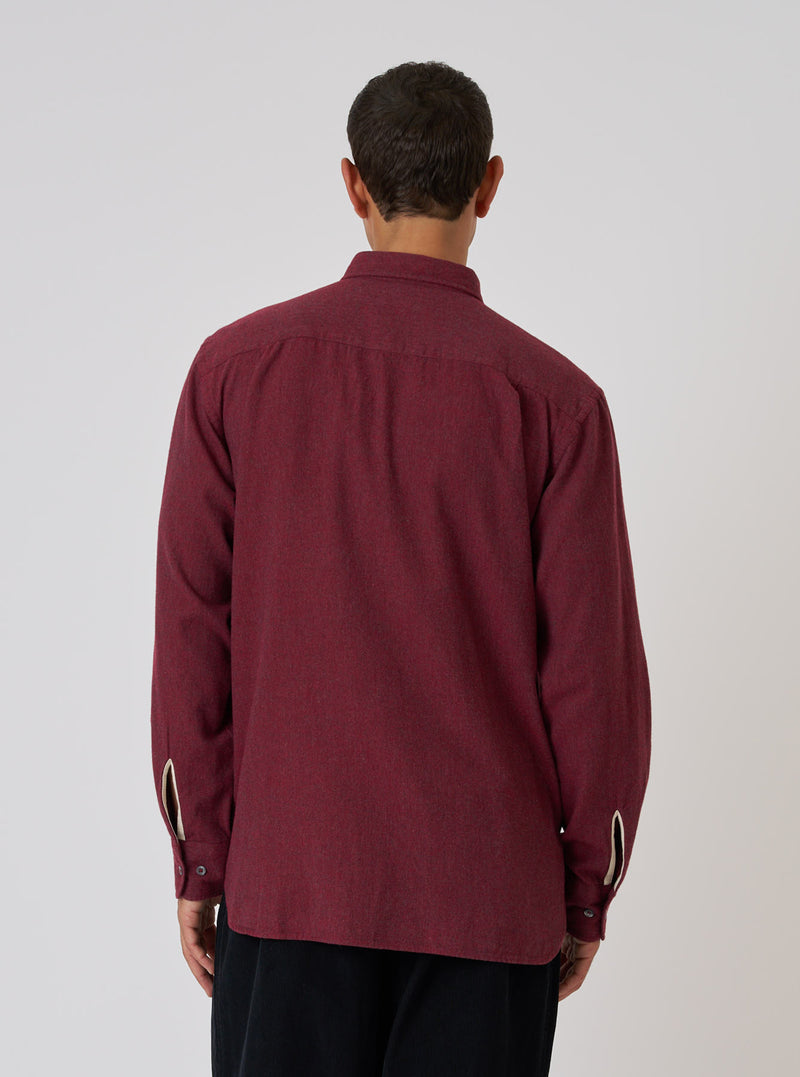Back view of a model wearing the Red Brushed Marl Twill Square Pocket Shirt. The shirt is a deep red color and made of a textured twill material. Shot against a plain white backdrop.