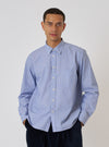 A man models the Blue Classic Stripe Lazy Day Shirt against a white backdrop. The shirt is buttoned and he has his hands in his pockets.