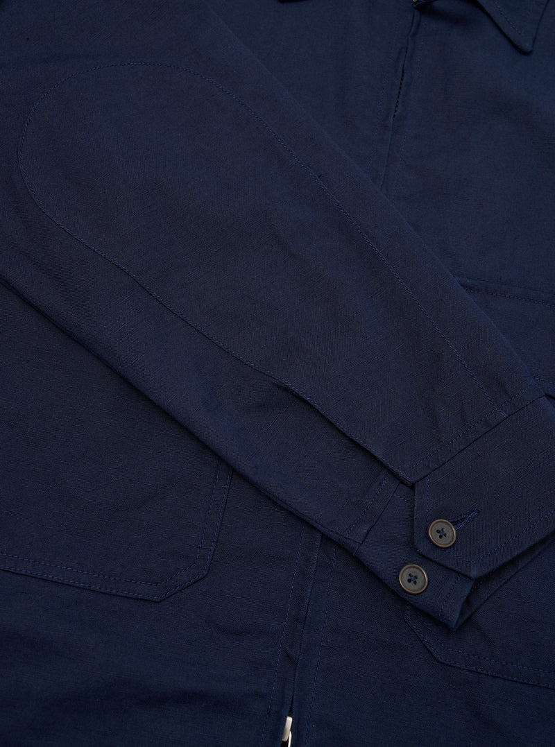 A rear view of the Navy Linen Slub Weave E130 Jacket is displayed flat against a plain white background. The image highlights the straight hem, the textured finish of the linen slub fabric, and the clean stitching across the shoulders and back panel.