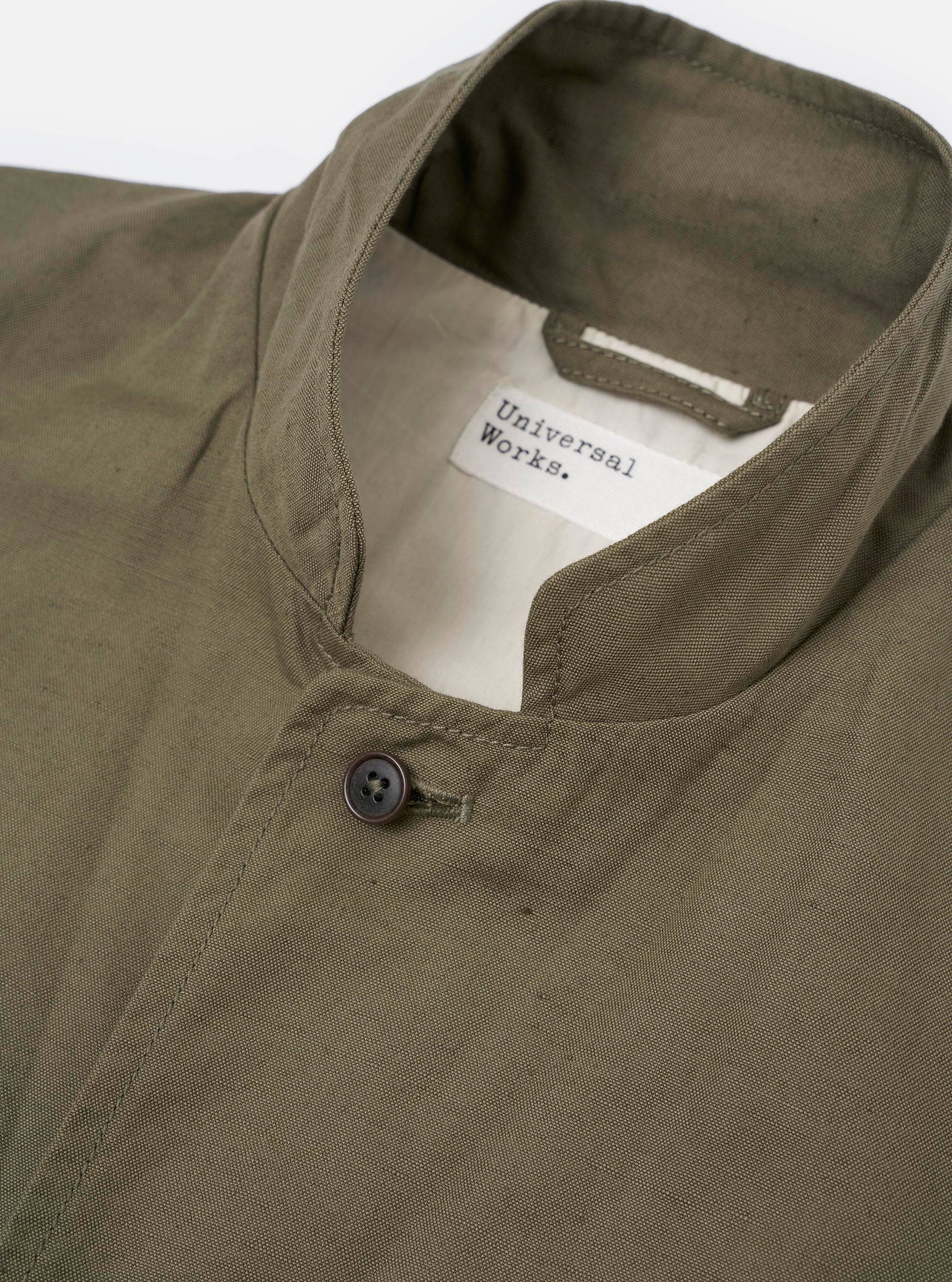 The Olive Linen Slub Weave Two Button Jacket is shown from a rear angle as a flat lay against a plain white background. The image highlights the jacket's structured back with a central vent at the hem and a visible slub texture in the olive green linen-cotton fabric.