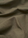 A close-up fabric swatch of the Olive Linen Slub Weave Bakers Jacket. The image shows the detailed texture and irregular weave of the olive green linen-blend fabric.