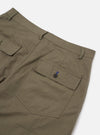 The Olive Linen Slub Weave Dizzy Trouser is shown in a close-up detail view as a flat lay against a plain white background. The image highlights the textured slub weave of the olive green linen-cotton fabric, focusing on the waistband and the construction of the front pockets.