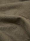 A close-up swatch image of the Olive Linen Slub Weave Dizzy Trouser fabric highlights the olive green color and the textured, irregular slub weave of the material.