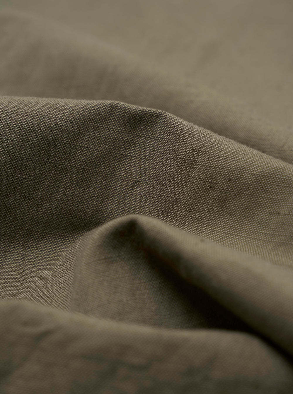 A close-up swatch image of the Olive Linen Slub Weave Oxford Pant fabric displays an olive green color with a visible textured slub weave pattern. The irregular, raised texture of the linen and cotton blend material is clearly visible against a neutral background.