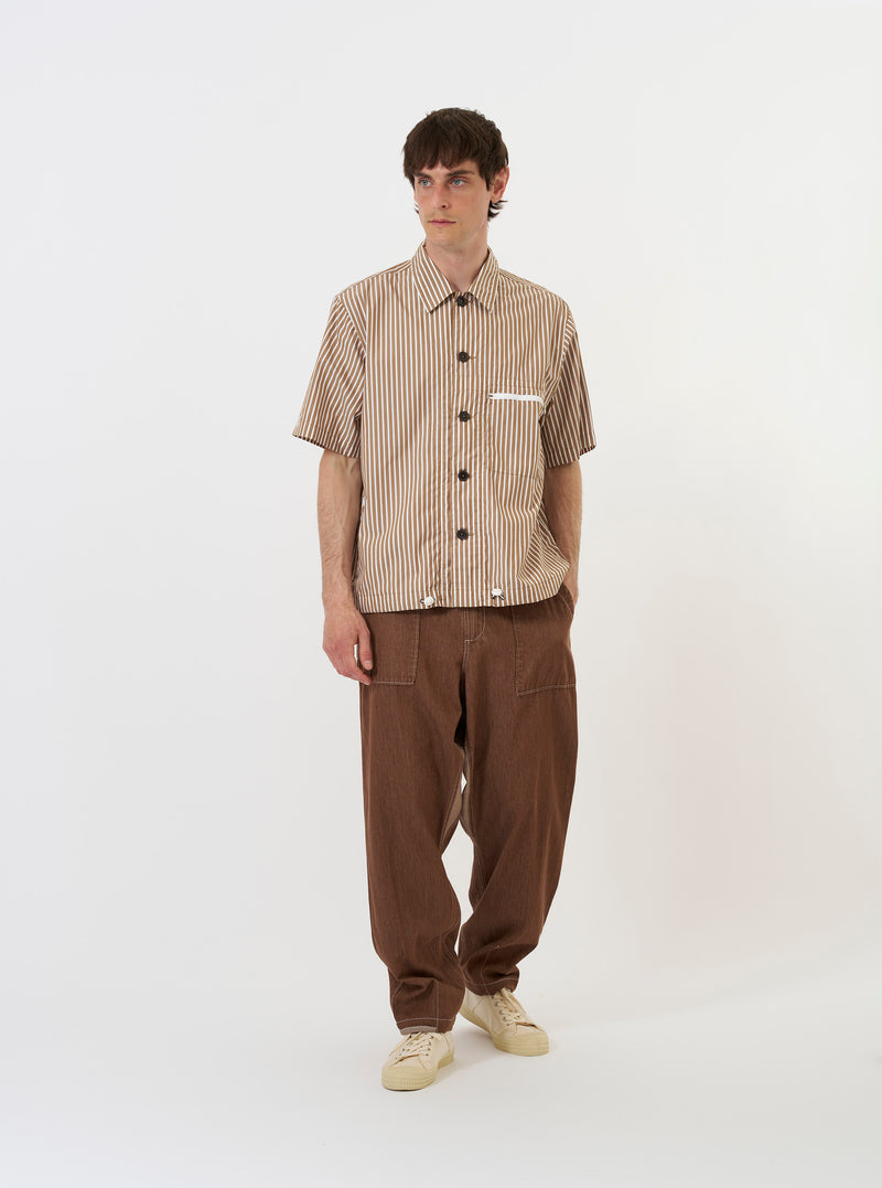 The Brown/White Cotton Stripe Z Tech Overshirt is shown laid flat against a plain white background. The garment features horizontal brown and white stripes, a classic pointed collar, a full button-down front, and two large chest pockets.