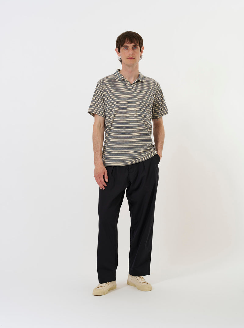 The Grey OS Stripe Jersey Vacation Polo is shown from a rear perspective, laid flat against a solid white background. The image highlights the horizontal grey and white stripes, the straight hem, and the back of the classic polo collar.