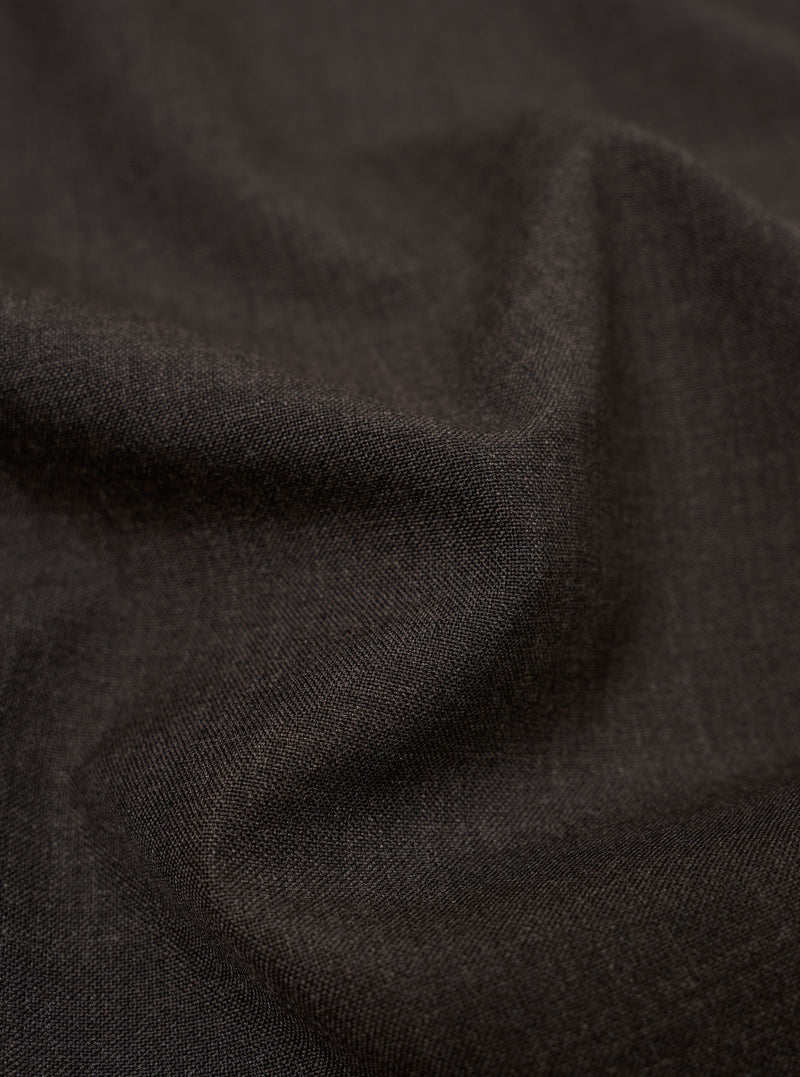 A close-up fabric swatch of the Brown Marl Tropical Suiting highlights the detailed texture and color of the material used for the Two Button Jacket. The image shows a fine, multi-tonal weave in shades of brown.
