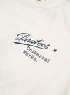 The Paraboot x Universal Works Ecru Single Jersey Print Tee is shown from a rear angle as a flat lay against a plain white background. The image highlights a large screen print on the back featuring a twist on Paraboot's retro graphic advertising. The t-shirt is made from a light ecru cotton fabric and features a relaxed fit with a straight hem.