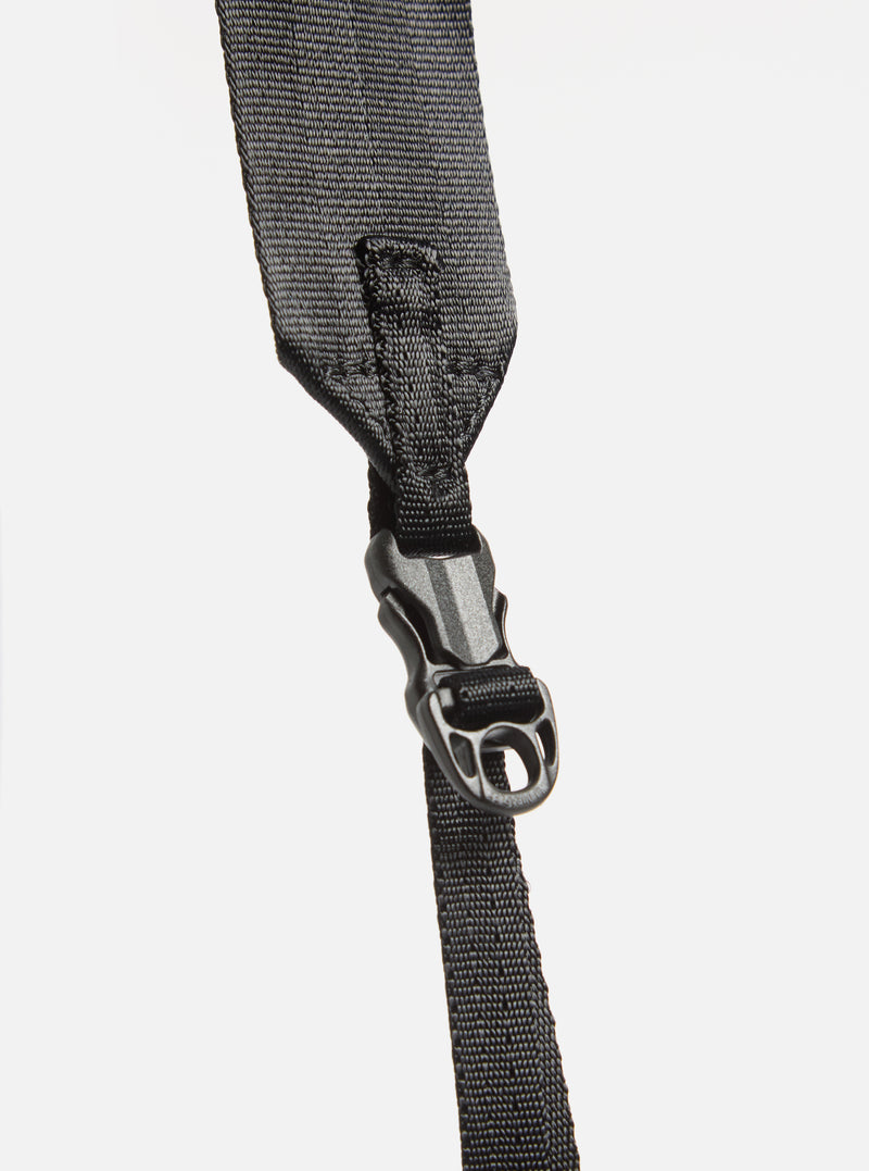 Close-up of the black nylon strap and buckle of the F/CE.® Green Nylon 2.5 Layer Sacoche against a white backdrop. The strap's texture and buckle details are clearly visible.