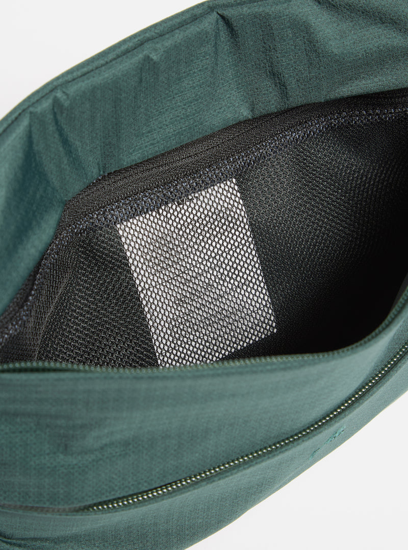 Close-up of the F/CE.® Green Nylon 2.5 Layer Sacoche interior, showing a black mesh pocket against a plain white background. The sacoche is a deep green color.