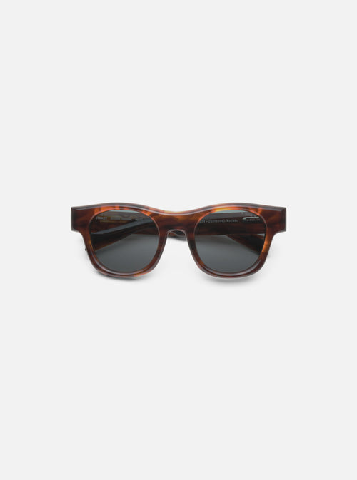 Close-up of A. SOCIETY x Universal Works Brown Stanley Sunglasses on a clean white background. The frames are brown with a tortoise shell pattern and dark lenses.