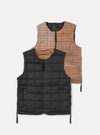 The TAION x Universal Works Reversible Black Military Line Vest on a white background. One side is black quilted nylon, the other is brown and beige houndstooth wool.