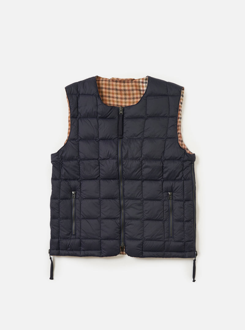 The TAION x Universal Works Reversible Dark Navy Military Line Vest on a white background. The vest is dark navy with a brown and tan houndstooth pattern on the reverse side.