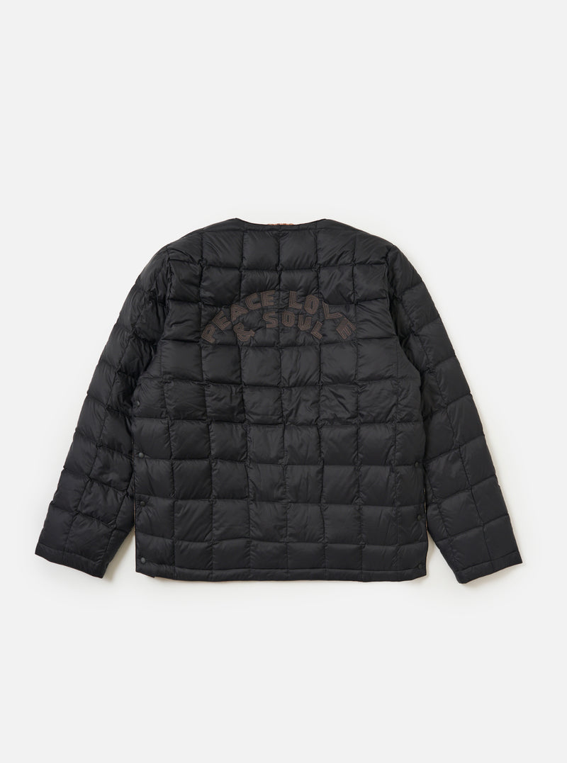 The TAION x Universal Works Reversible Black Military Line Liner Jacket, displayed on a white background. The jacket is black with a quilted pattern and "PEACE LOVE & SOUL" embroidered on the back.