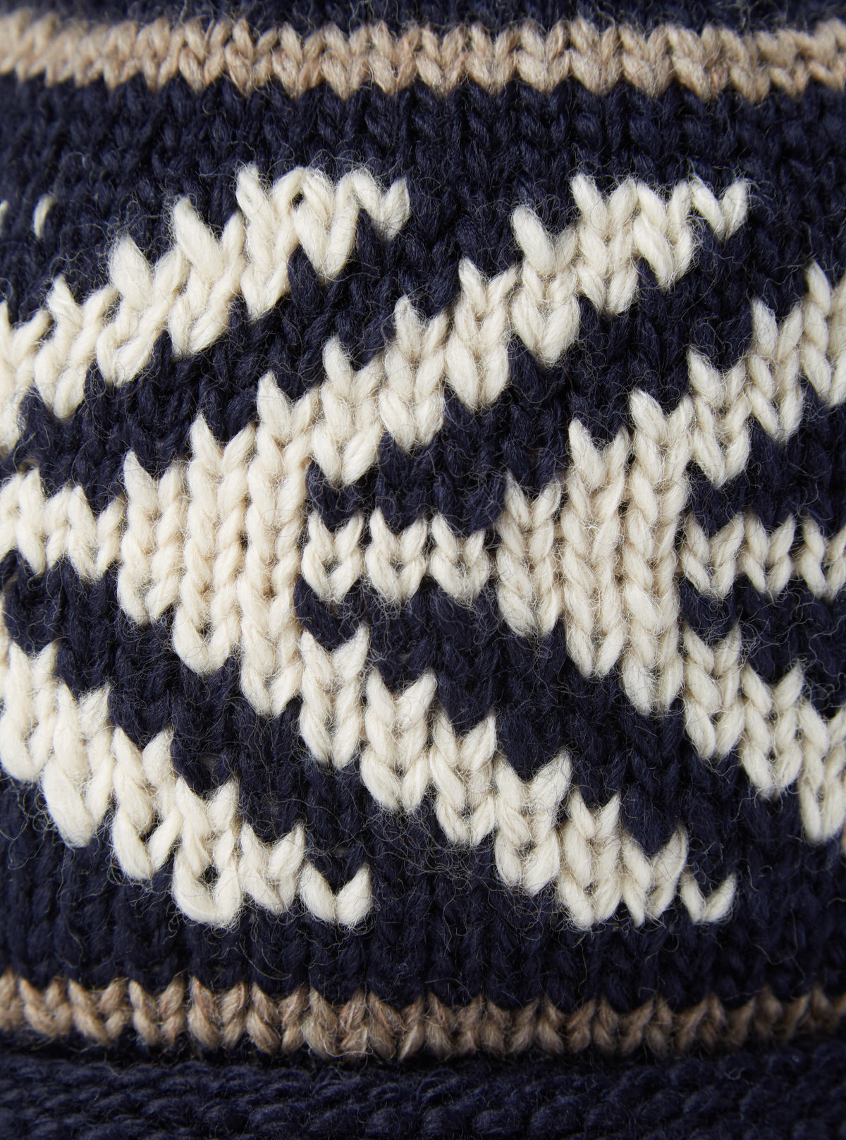 Side angle view of the cableami® Navy Wool Jacquard Watch Cap against a clean studio background, showing the fitted crown, textured wool knit weave, and dark navy tones of the beanie cap clearly.