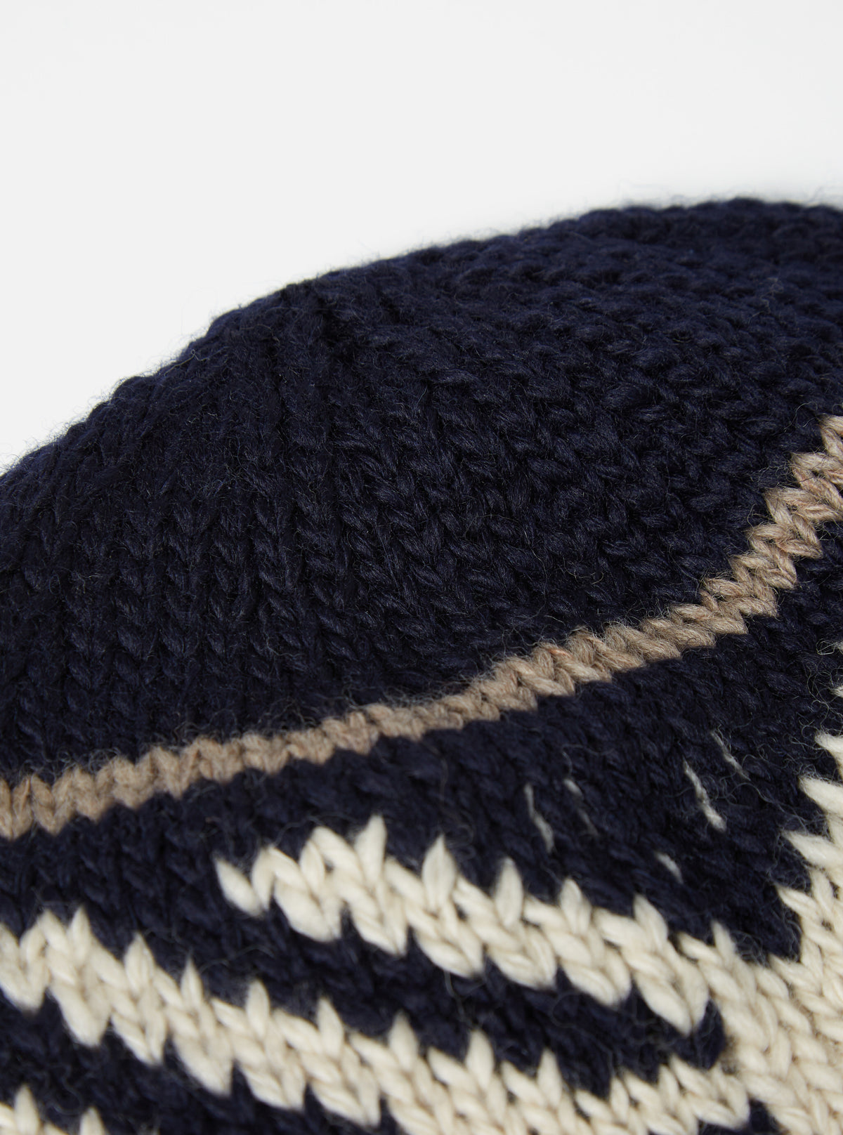 Front view of the cableami® Navy Wool Jacquard Watch Cap displayed on a neutral white background, showcasing the thick folded brim, textured pattern, and classic rounded beanie silhouette.