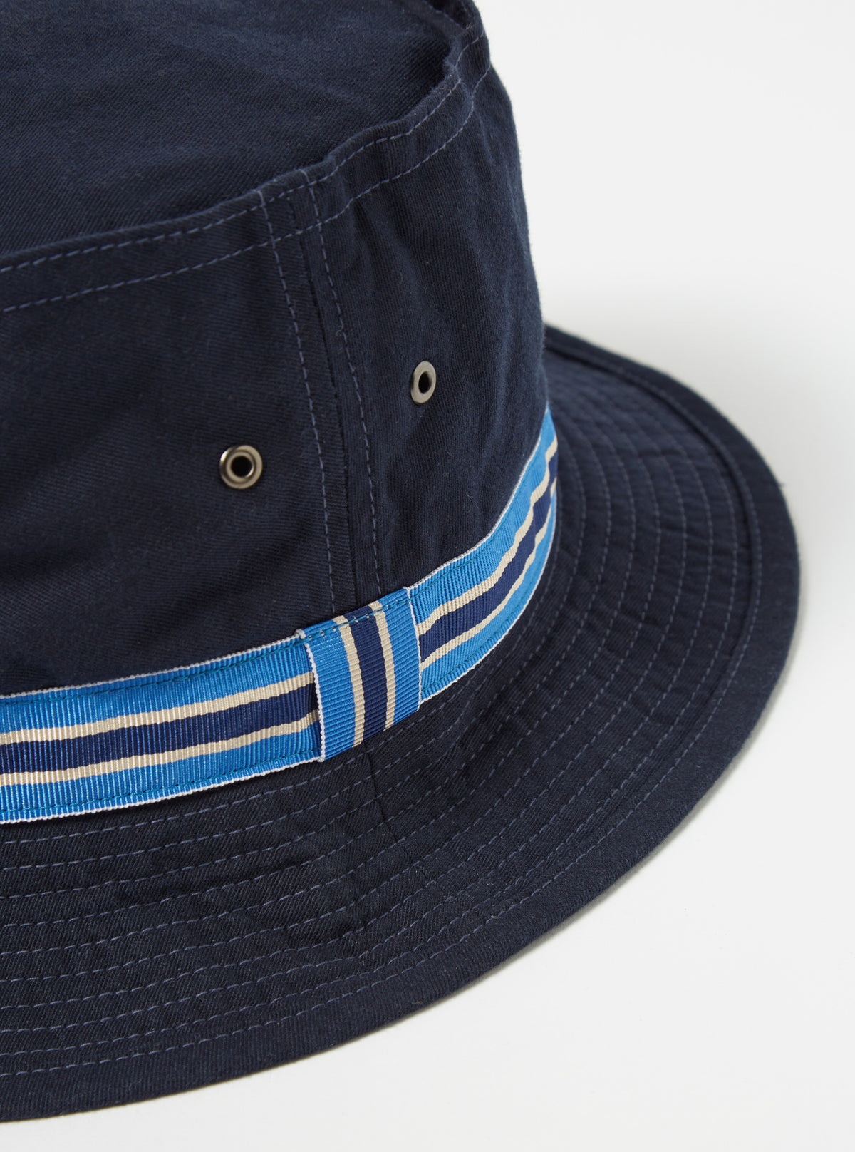 Close-up of the cableami® Navy Chino Cotton Loose Light Pork Pie Hat on a white background. The hat features a blue and beige striped band.