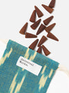 Harvest Incense Cones - Eucalyptus, Fir Needle & Patchouli - 20 pack, spilling from a blue and yellow patterned bag with a white label on a white background.
