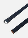 Close-up of a Navy Canvas O Ring Belt on a white background. The belt is made of navy canvas with a silver O-ring buckle and brown leather tip.