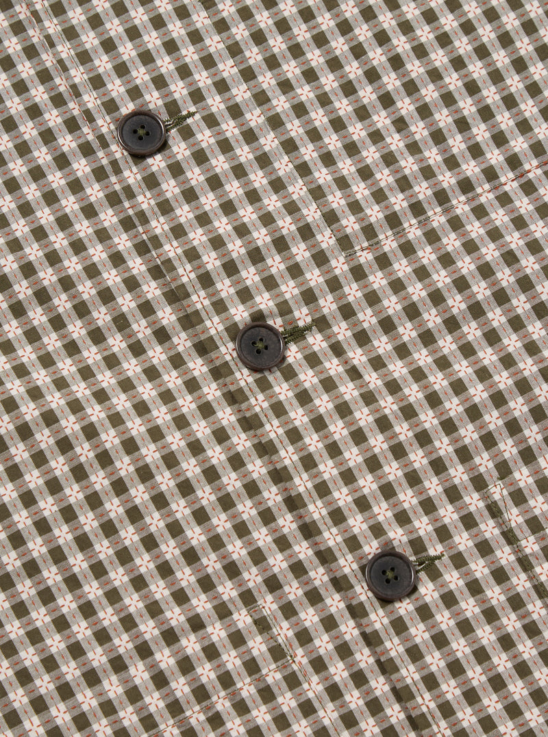 Close-up of the Olive Dobby Check Cancun Jacket fabric, showcasing the olive and white check pattern with small orange accents and dark brown buttons.