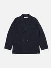The Navy Linen Slub Weave Manor Jacket, a double-breasted jacket in navy linen, is laid flat on a white background. The jacket has a relaxed fit and visible pockets.