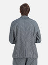 Back view of a model wearing an Indigo Hickory Stripe Denim Original Bakers Jacket. The jacket is blue and white striped. Shot on a white background.
