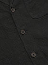 Close-up of the Charcoal Fine Linen Mix Three Button Jacket, showcasing the fabric texture and button details. The jacket is neatly displayed on a flat surface.