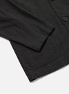 Close-up of the Charcoal Fine Linen Mix Three Button Jacket showing the texture and fit. The jacket is on a white surface.