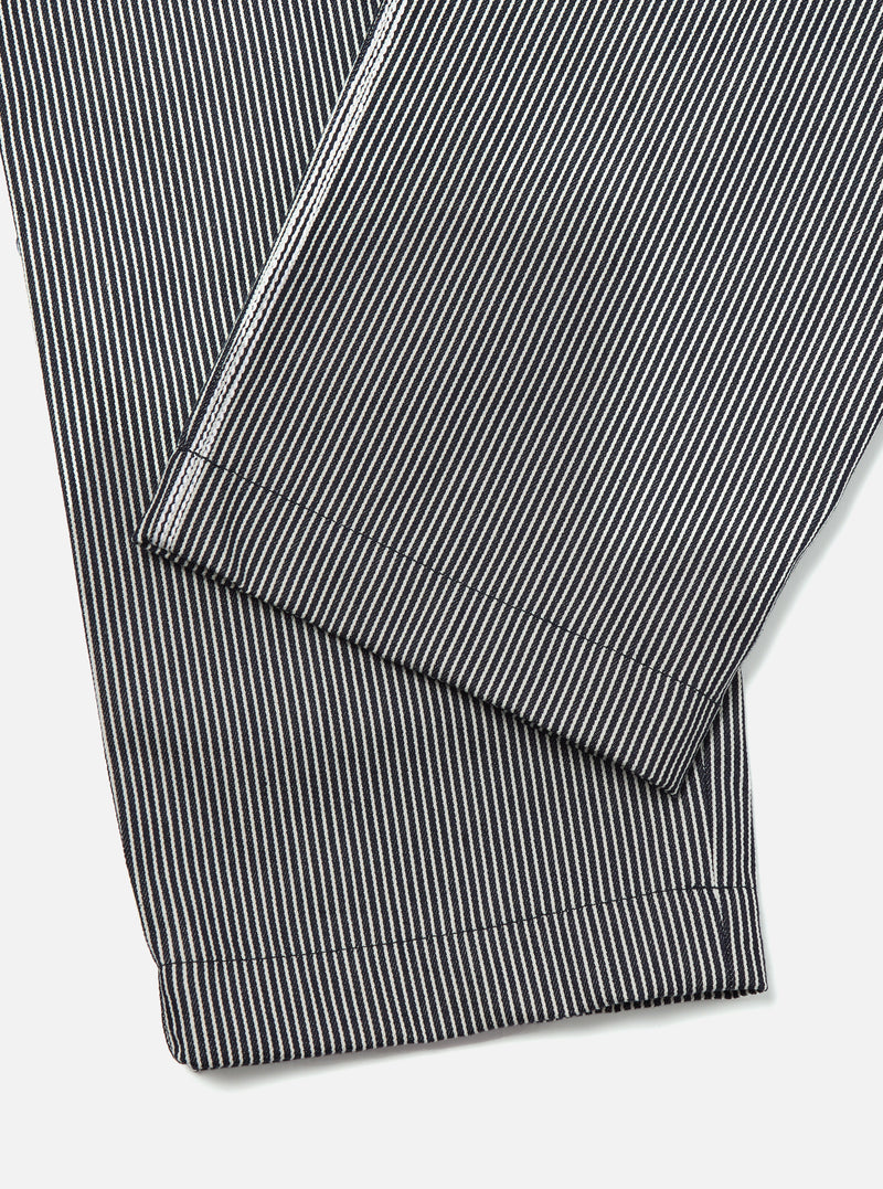 Close-up of the Indigo Hickory Stripe Denim Duke Pant. The denim material features vertical indigo and white stripes. The pants are neatly folded on a white surface.