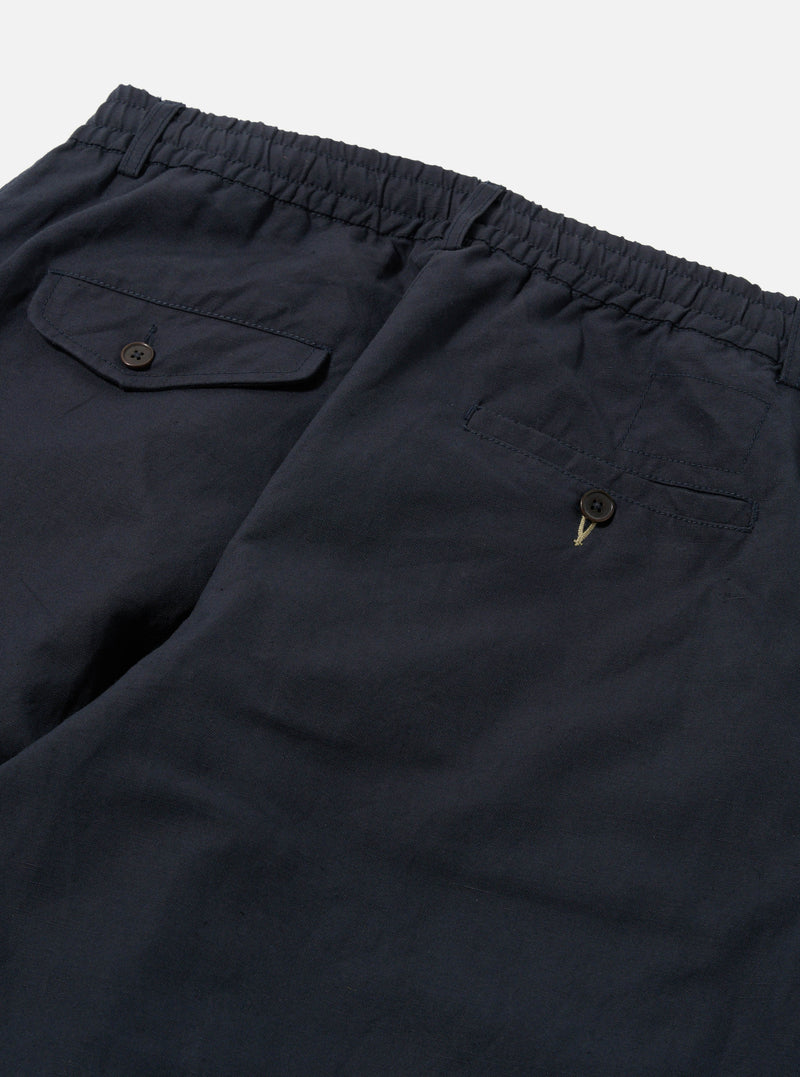 Close-up of the back of Navy Linen Slub Weave Oxford Pant on a white background. Shows the elastic waistband and buttoned pockets.