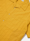 Close-up of the Mustard Dobby Self Stripe Camper Shirt on a white background. The shirt is a vibrant mustard color with a subtle dobby stripe pattern and short sleeves.