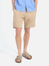 A man stands against a white backdrop, showcasing the Sand Military Cotton Simple Short. The shorts are paired with a blue shirt and casual sandals.