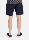 Back view of a model wearing Navy Military Cotton Simple Short on a white background. The shorts are paired with navy sneakers.