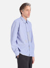 A man models the Mixed Blue Mixed Classics Patched Lazy Day Shirt. The light blue, button-down shirt features patchwork details. Shot in a studio with a white background.