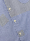 Close-up of the Mixed Blue Mixed Classics Patched Lazy Day Shirt, showing the blue and grey striped fabric and button details. The shirt is neatly laid out on a flat surface.