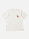 The Ecru/Red Single Jersey Print Pocket Tee on a white background. The tee is ecru with a red print on the pocket. The shirt is made of single jersey material.