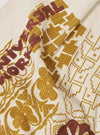 Close-up of the Ecru Acapulco Weave Kingsman Neckerchief, featuring a detailed floral and geometric pattern in ecru, gold, and brown hues on a textured fabric.