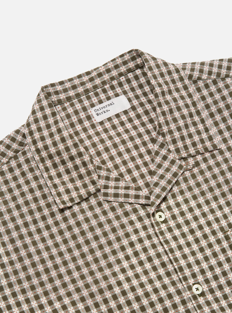 Close-up of the Olive Dobby Check Road Shirt on a white background. The shirt features an olive and white check pattern with small red accents. The collar and buttons are visible.