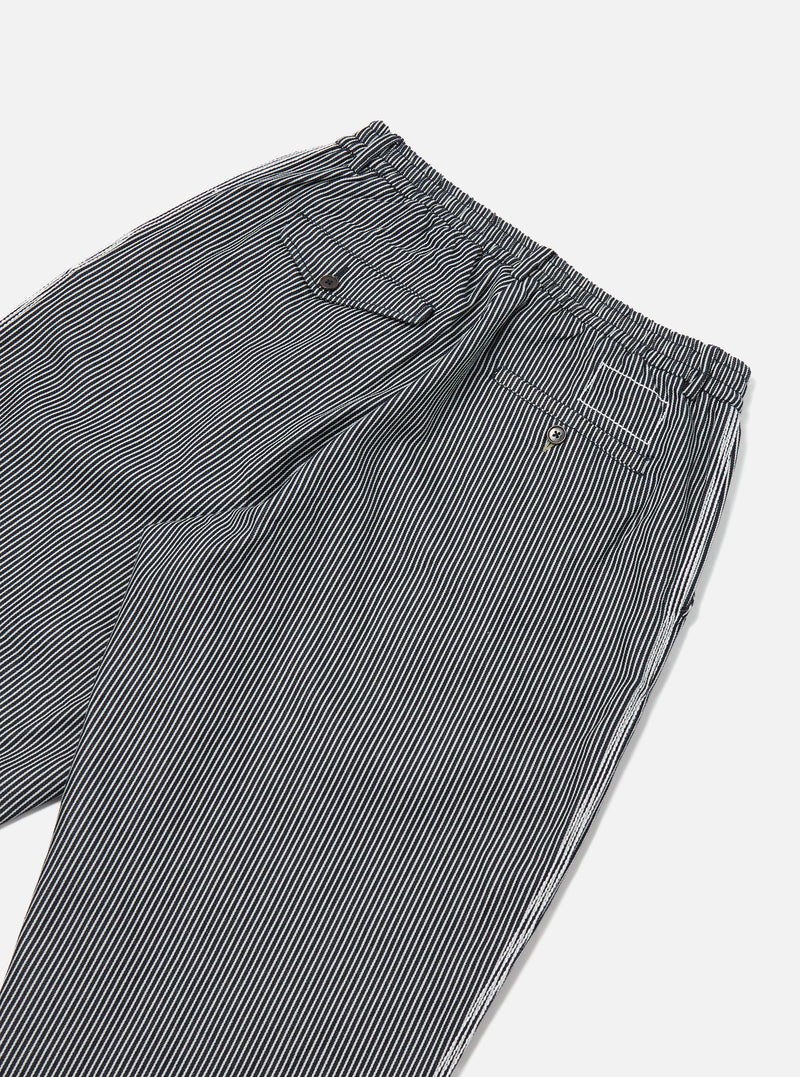 Close-up of the Indigo Hickory Stripe Denim Pleated Track Pant on a white background. The pants feature a striped pattern and a comfortable, relaxed fit.