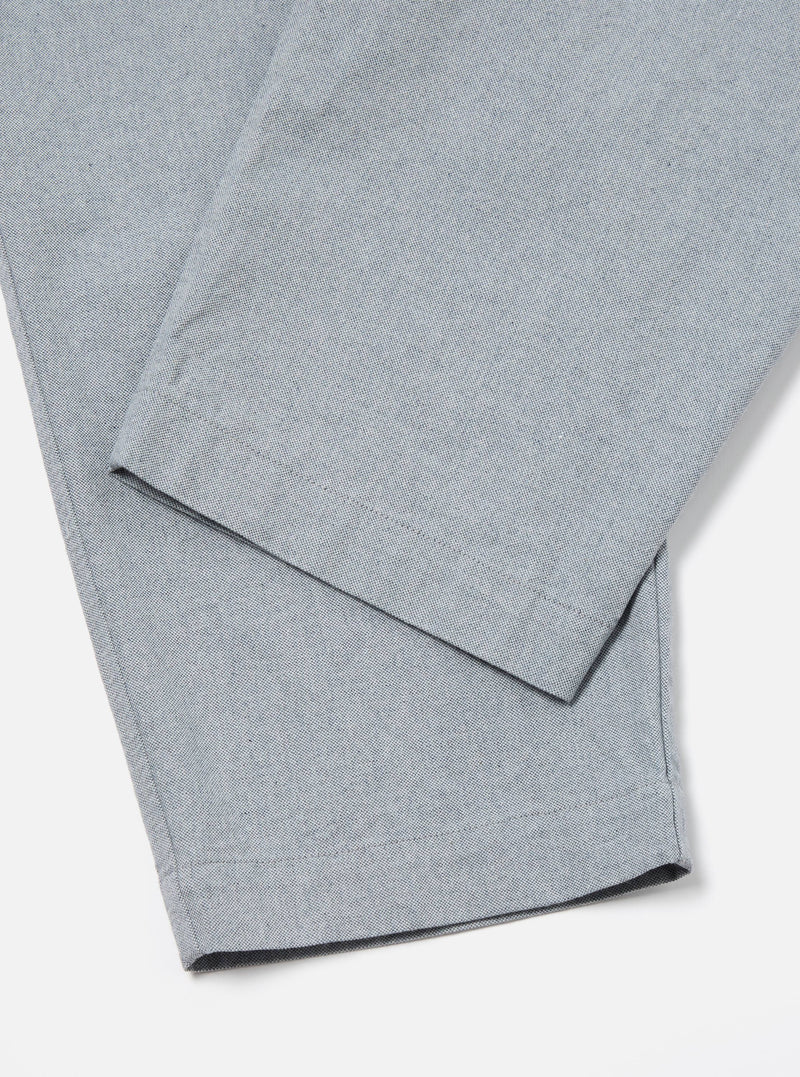 Close-up of the Indigo Reworked Jean Cloth Oxford Pant in light blue on a white background. The fabric has a subtle texture.