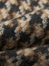 Close-up of the tweed fabric of the Sand Cortina Tweed Long Swing Coat, showing the texture and pattern in shades of sand, brown, and black.