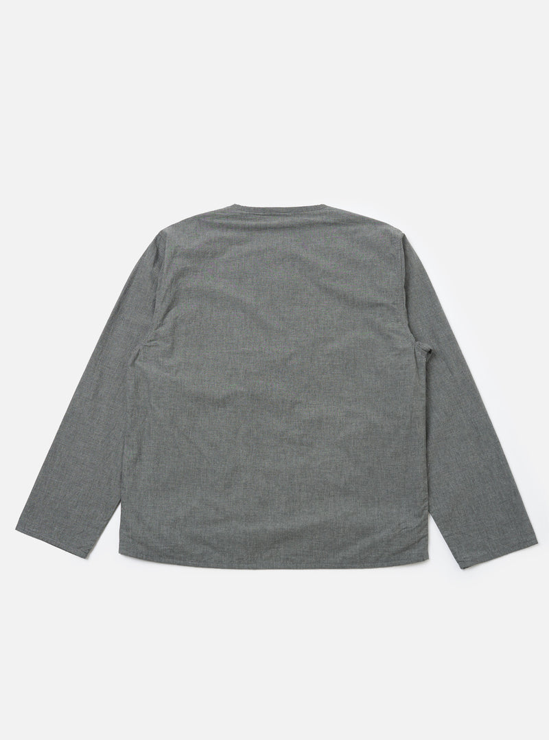 The Charcoal Organic Chambray Parachute Liner Jacket in charcoal gray, laid flat on a white background. The jacket is long-sleeved and made of a textured chambray material.