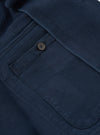 Close-up of the dark navy Patchwork Weave Cotton Labour Jacket, showing the textured weave, button detail, and pocket. Shot on a flat surface.